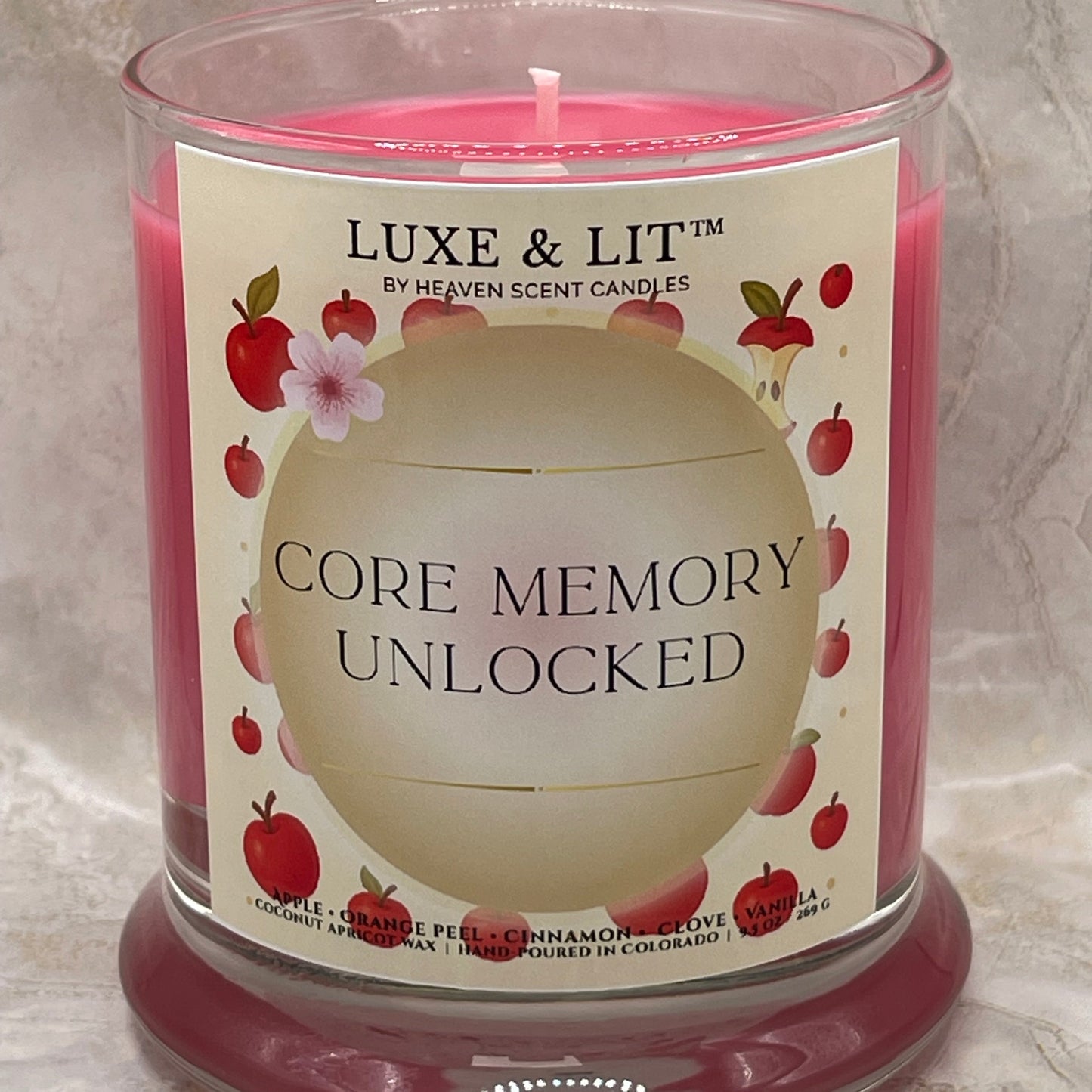Luxe & Lit candle with 'Core Memory Unlocked' label on a marble surface