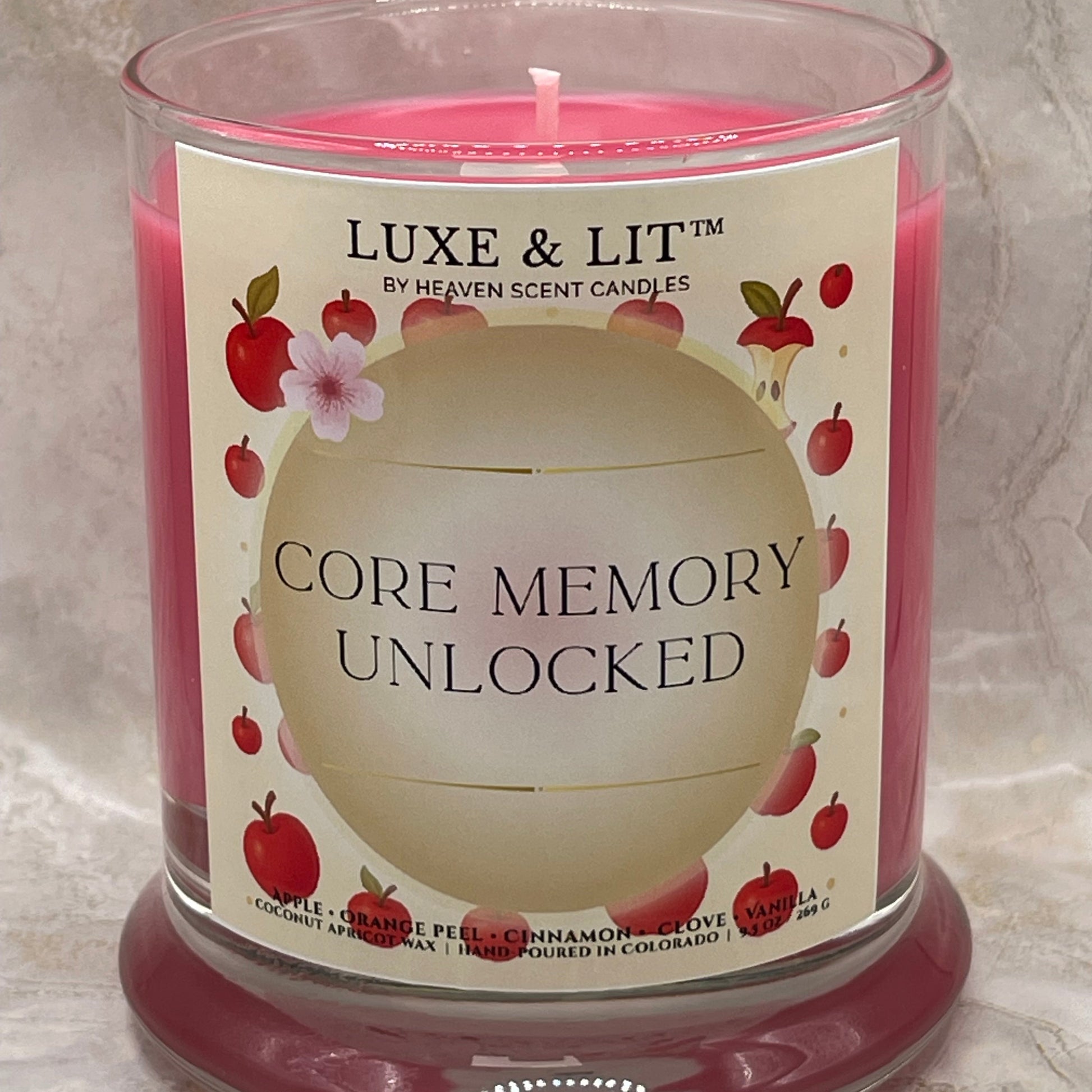 Luxe & Lit candle with 'Core Memory Unlocked' label on a marble surface